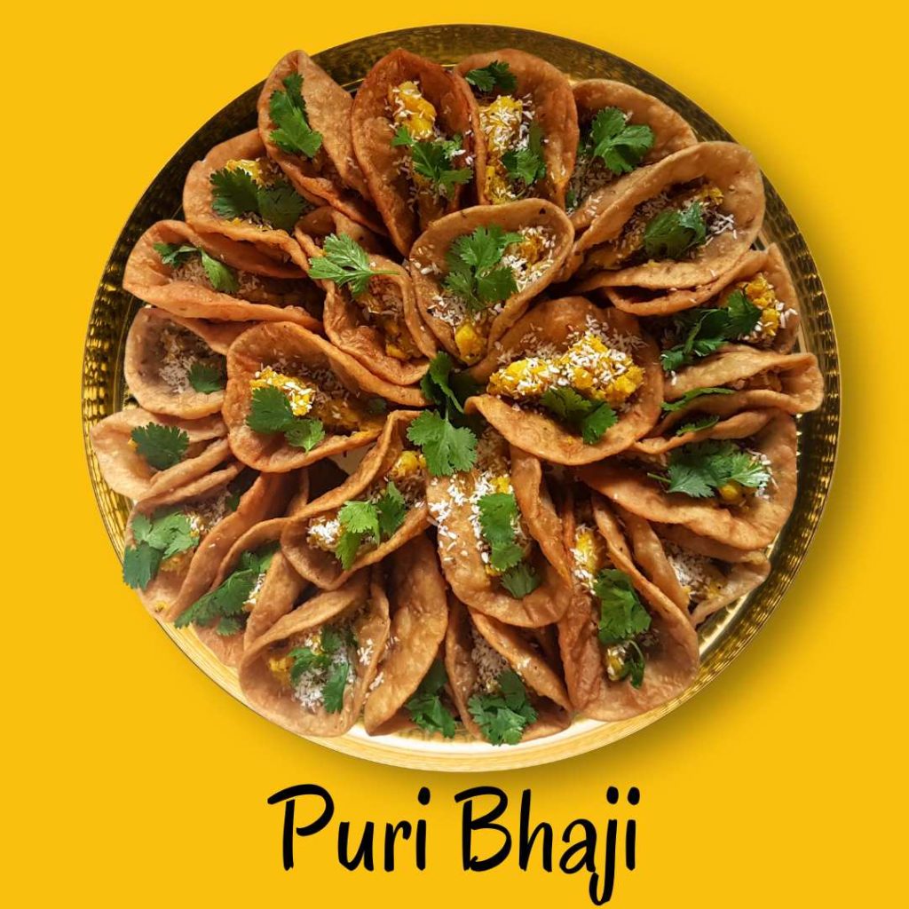 Platter of puri bhaji featuring crispy puris and flavorful potato curry, showcasing a traditional Indian meal.